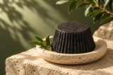 AI-generated campaign illustration: shampoo bar on a stone tray